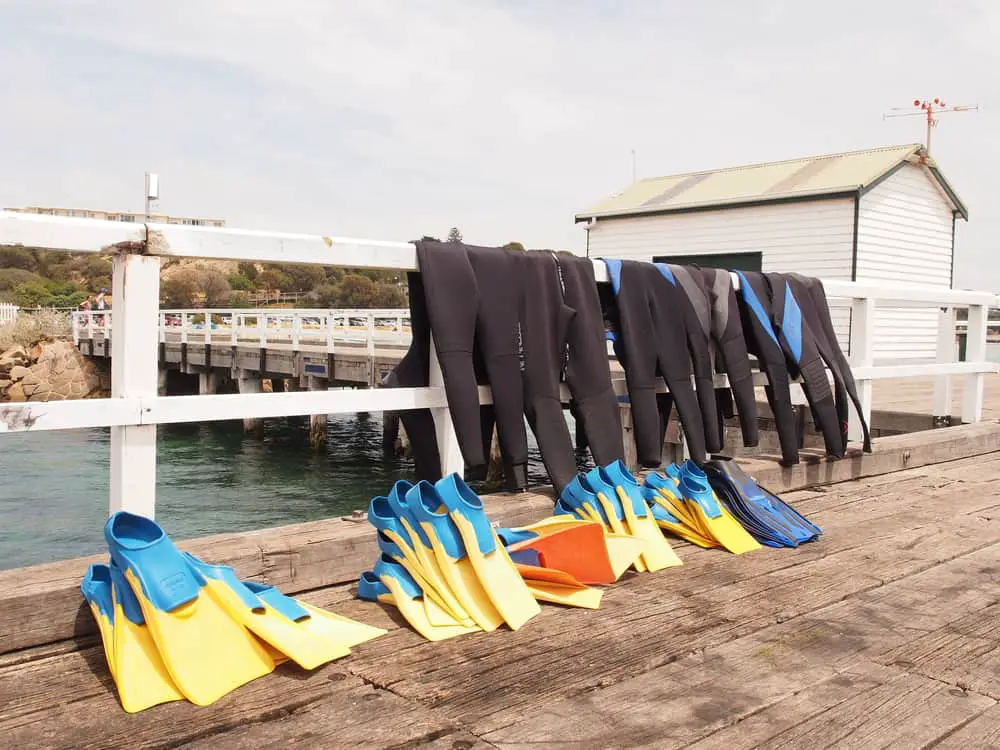 Wetsuits for divers drying on a pier