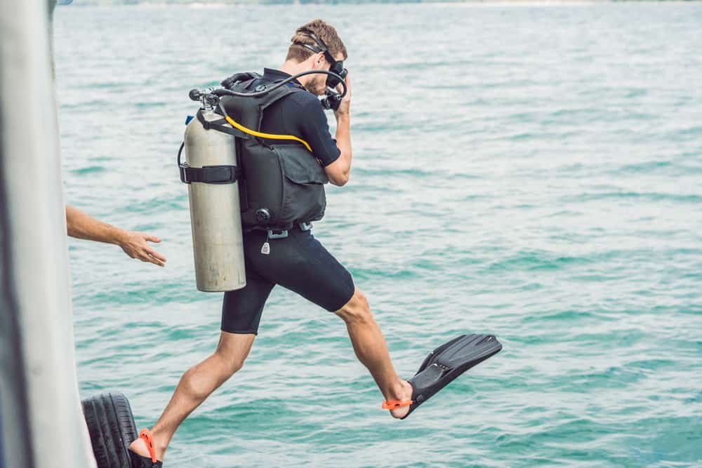 Diver taking a giant stride to enter the water