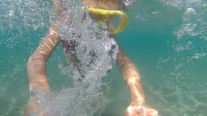 Clearing a snorkel mask by blowing in through your nose