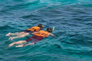 Using a snorkel vest to stay afloat